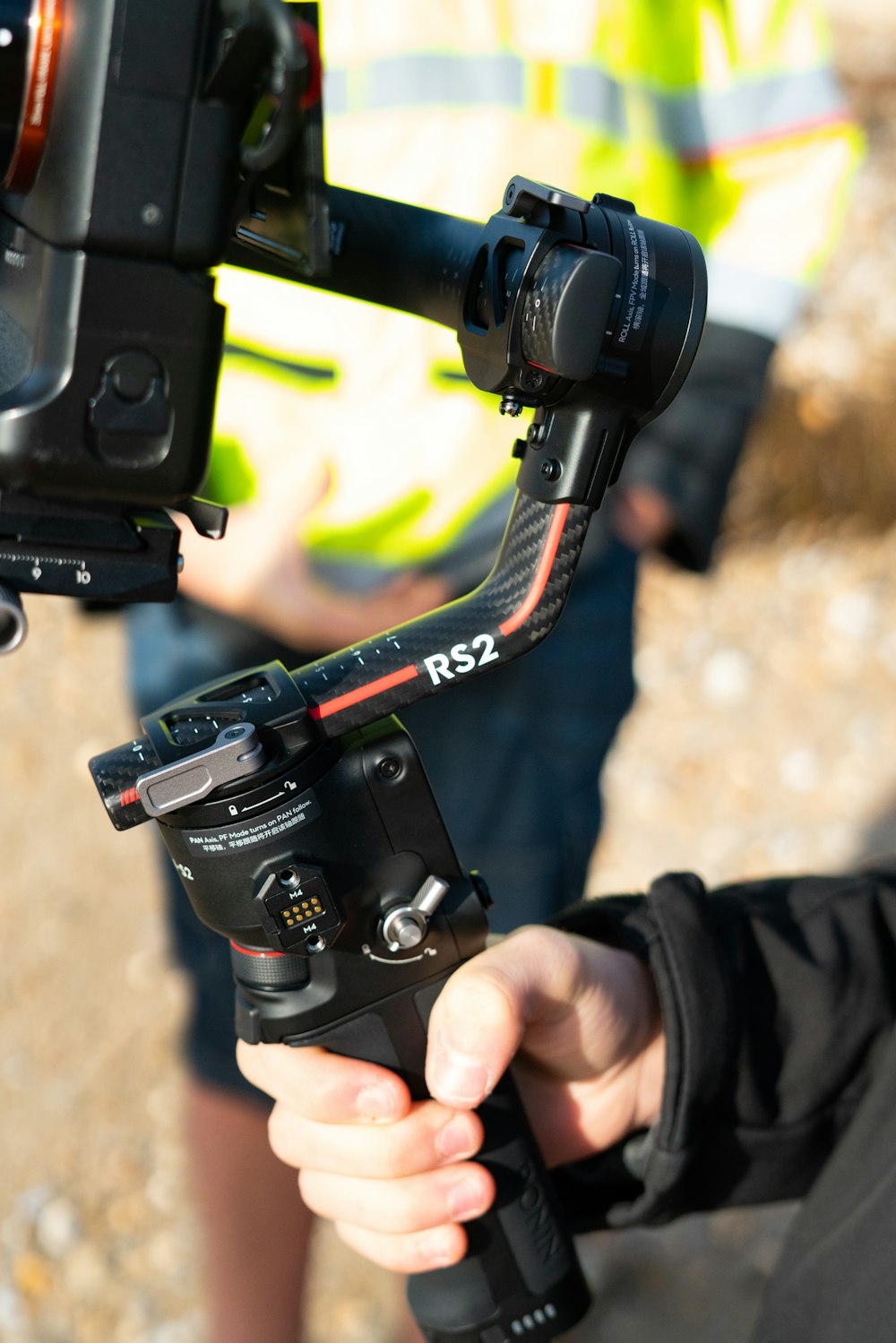 person holding black and red nikon dslr camera