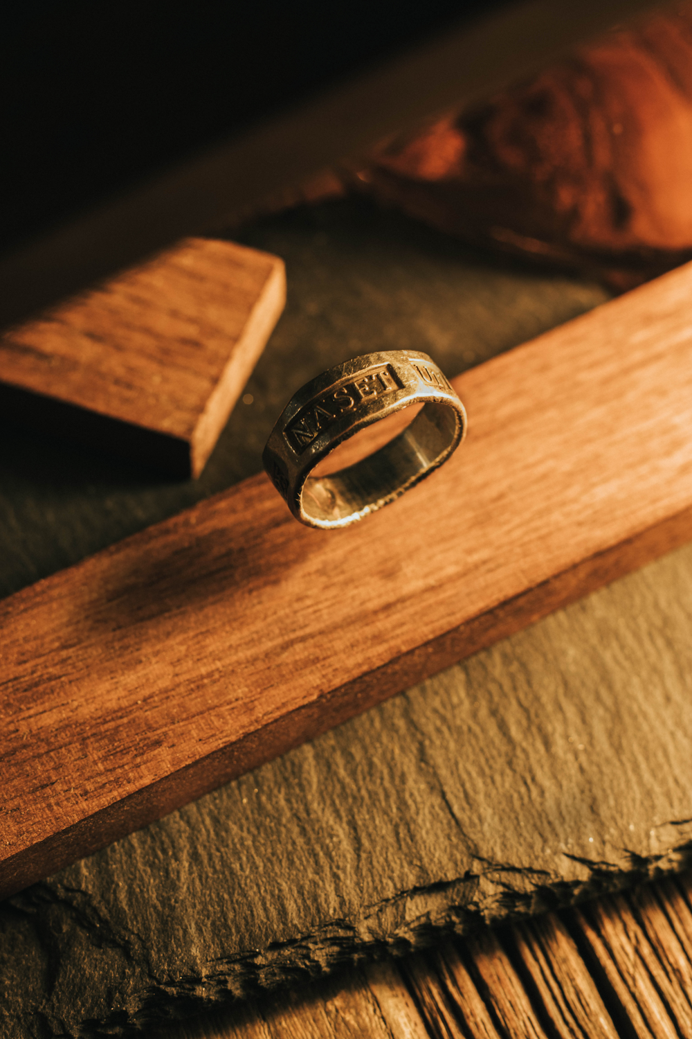 silver ring on brown wooden table