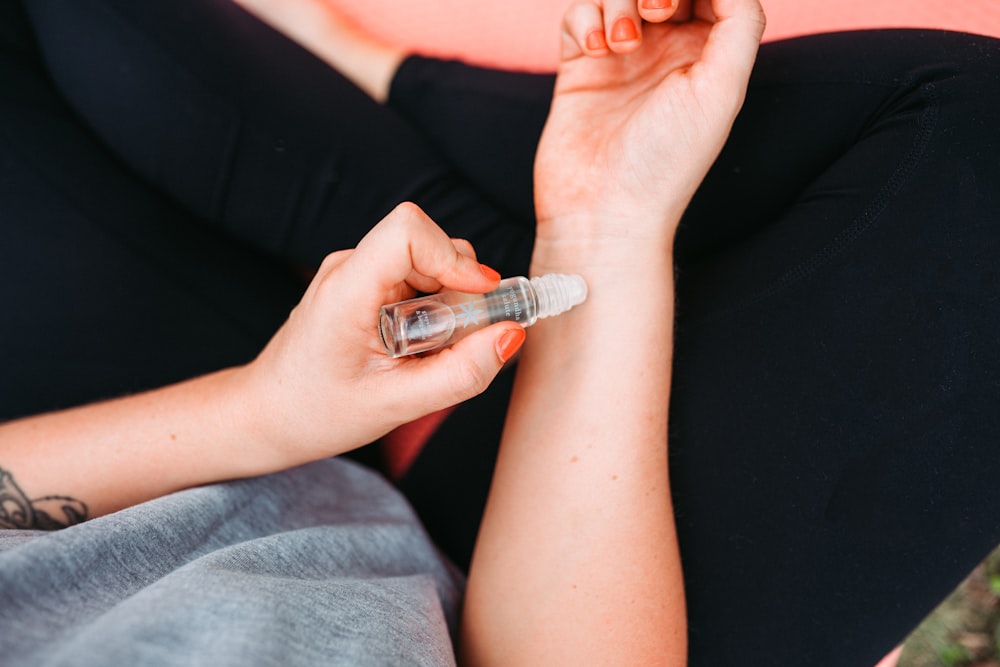 person holding silver nail polish