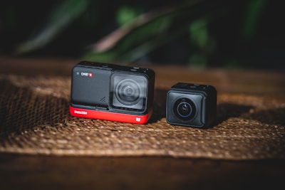 black and orange camera on brown surface