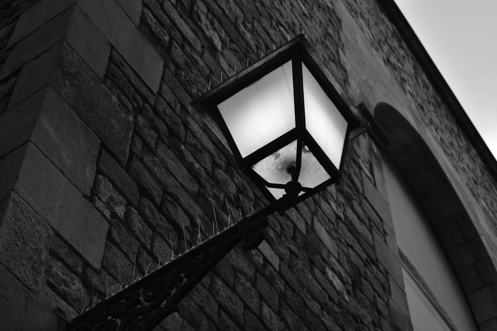 black framed wall lamp turned on during daytime