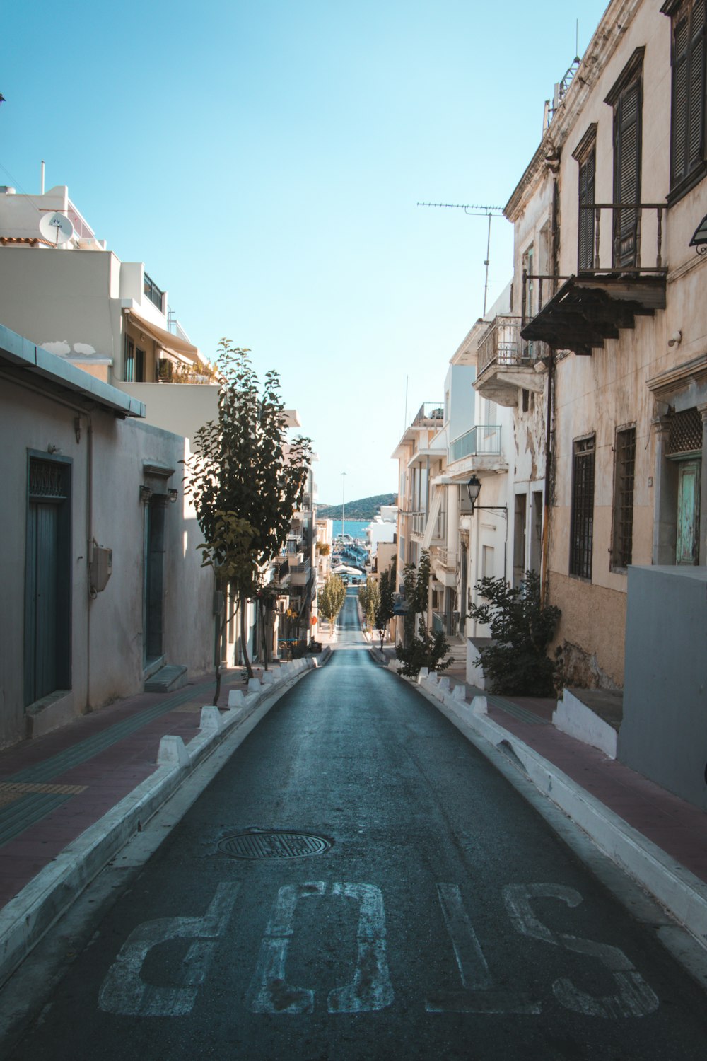 empty road between concrete buildings during daytime