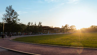 A warm community gathering with families and children sharing smiles in a sunny park.