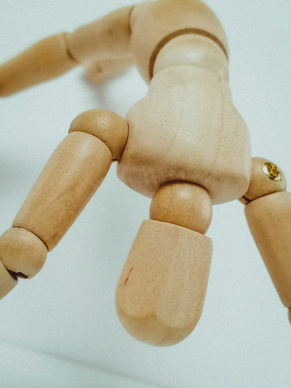 brown wooden human figure on white surface