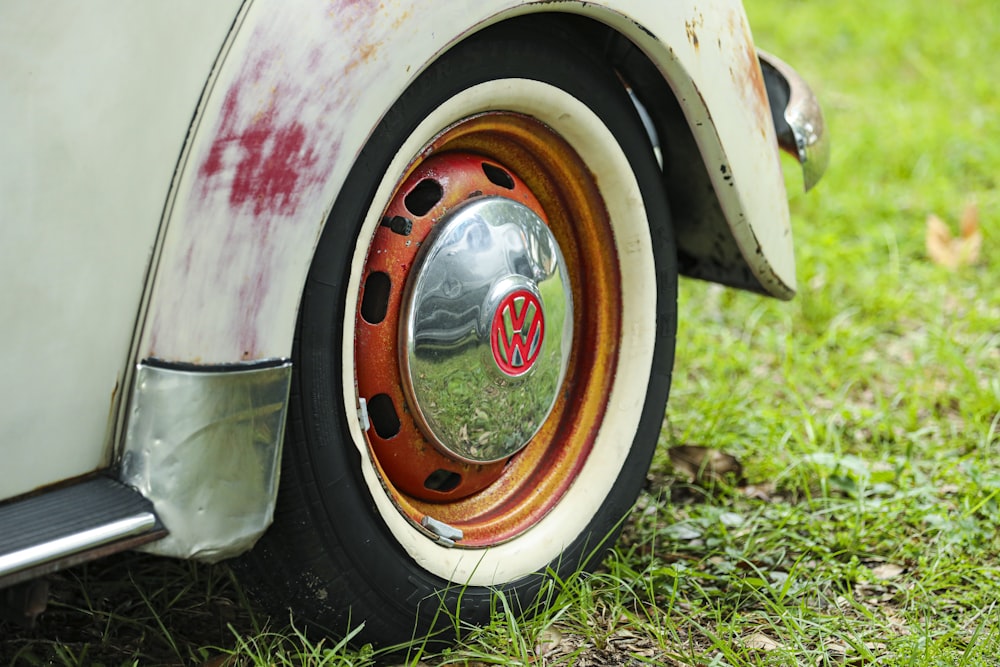 white and red car on green grass during daytime