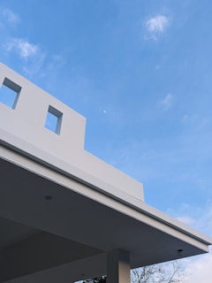 A scenic view of a recently finished minimalist building with clean lines and bright exterior.