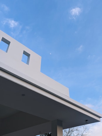 A scenic view of a recently finished minimalist building with clean lines and bright exterior.