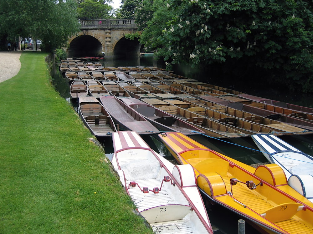 yellow and white boat on green grass during daytime