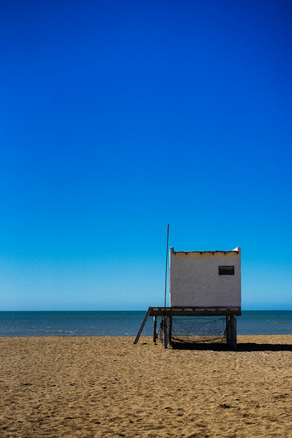 Maison de sauveteur en bois blanc sur le bord de la plage pendant la journée