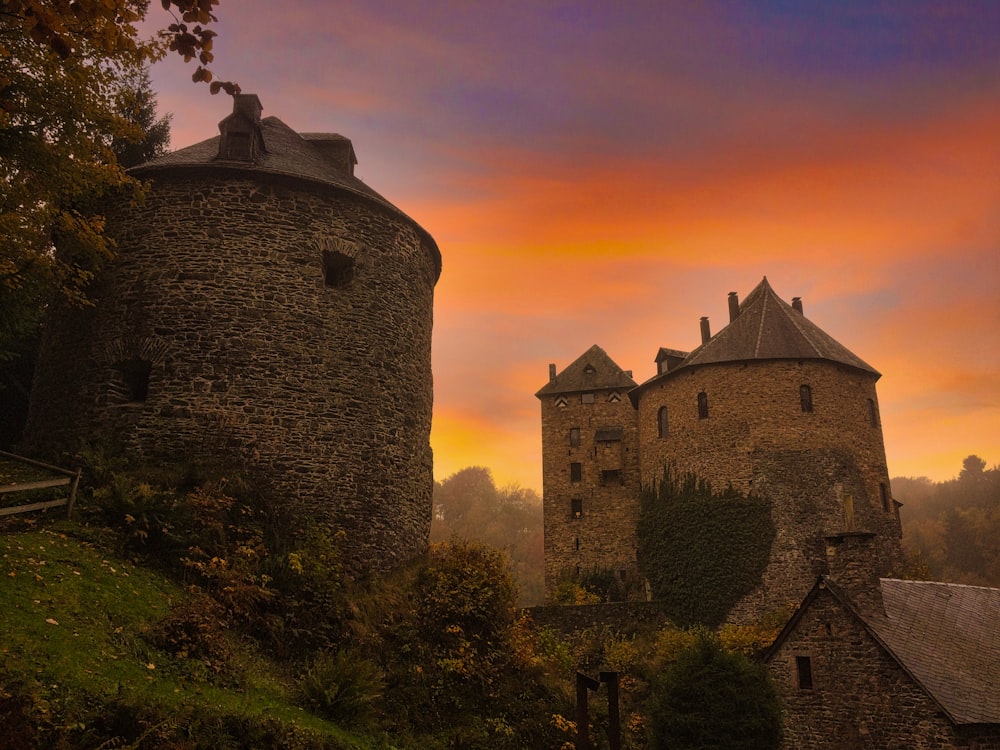 brown concrete castle on green grass field during sunset