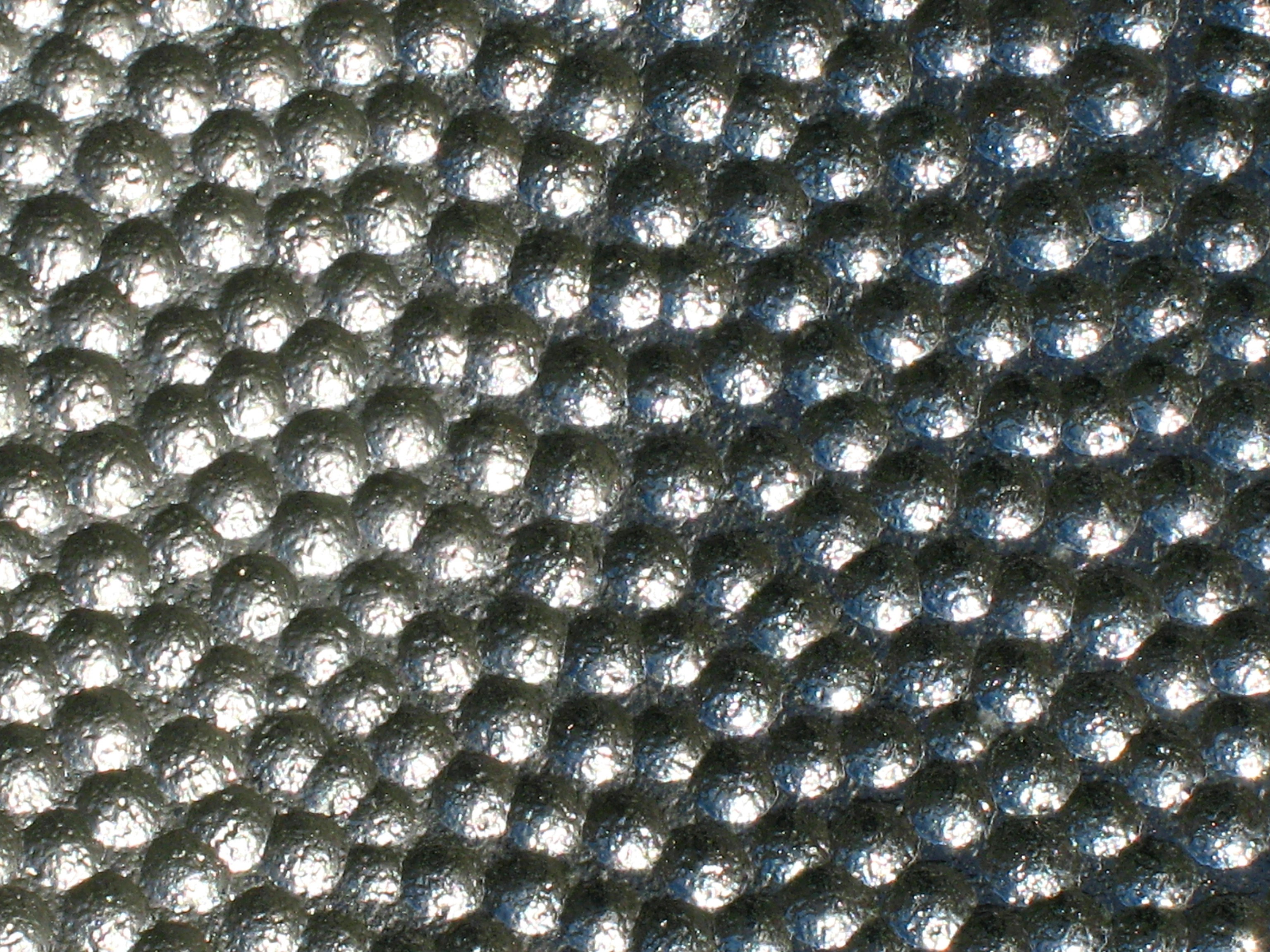 Dimple pattern on a coin-operated binocular device on the Chelsea docks in Manhattan, NY.