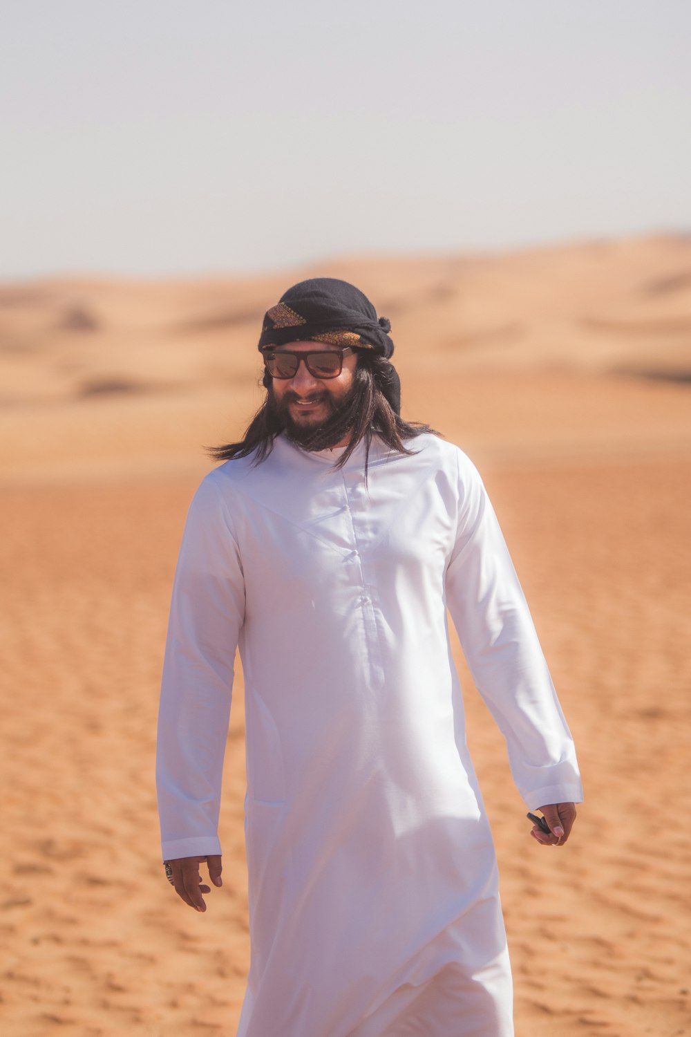 man in white long sleeve shirt wearing black sunglasses