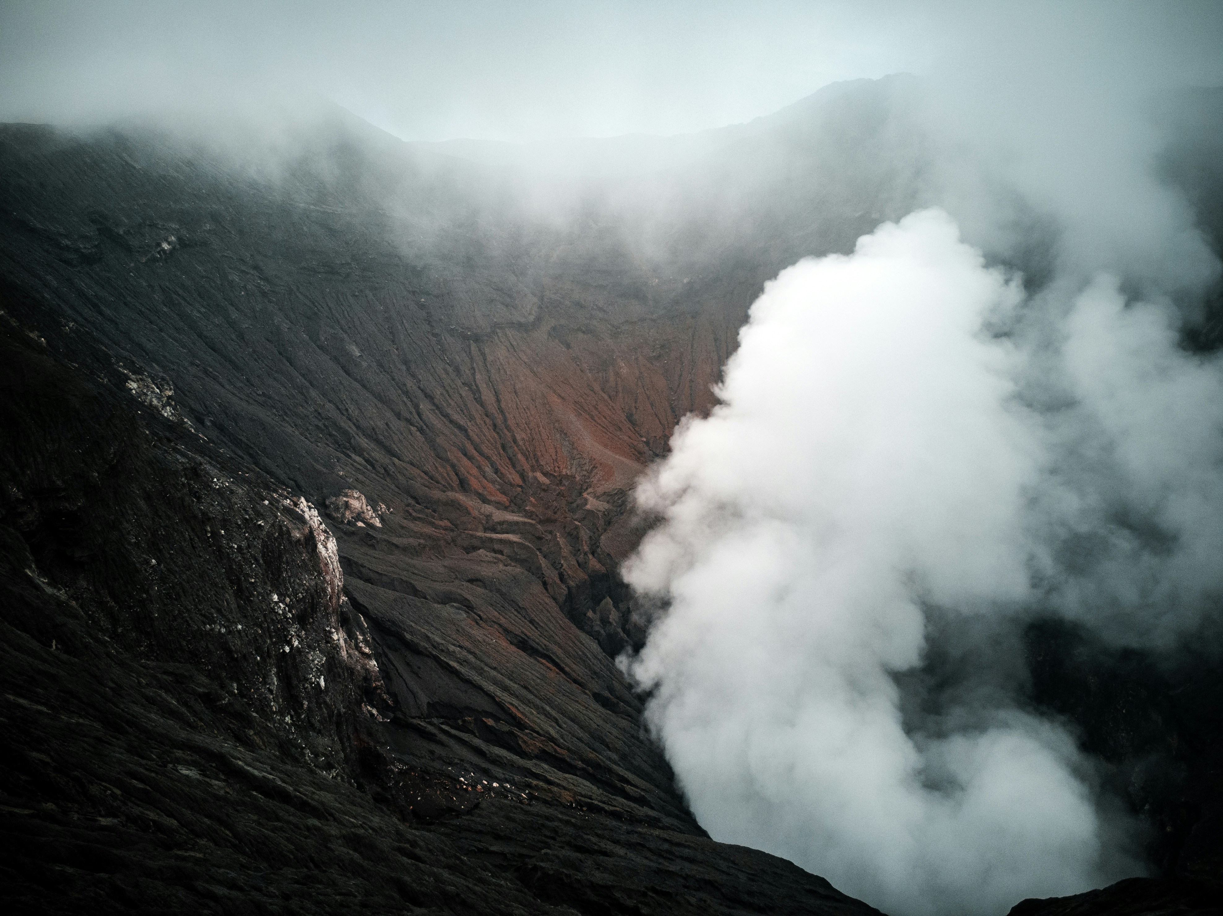 brown mountain with white clouds