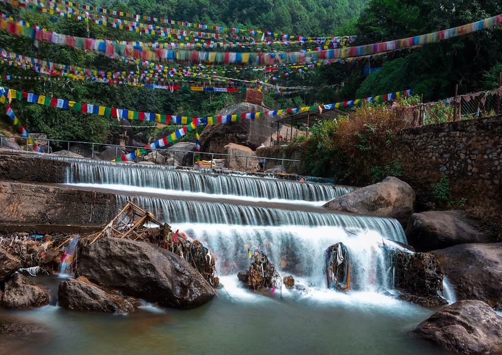 water falls with multi colored rope