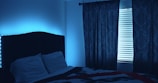 white pillow on bed near window