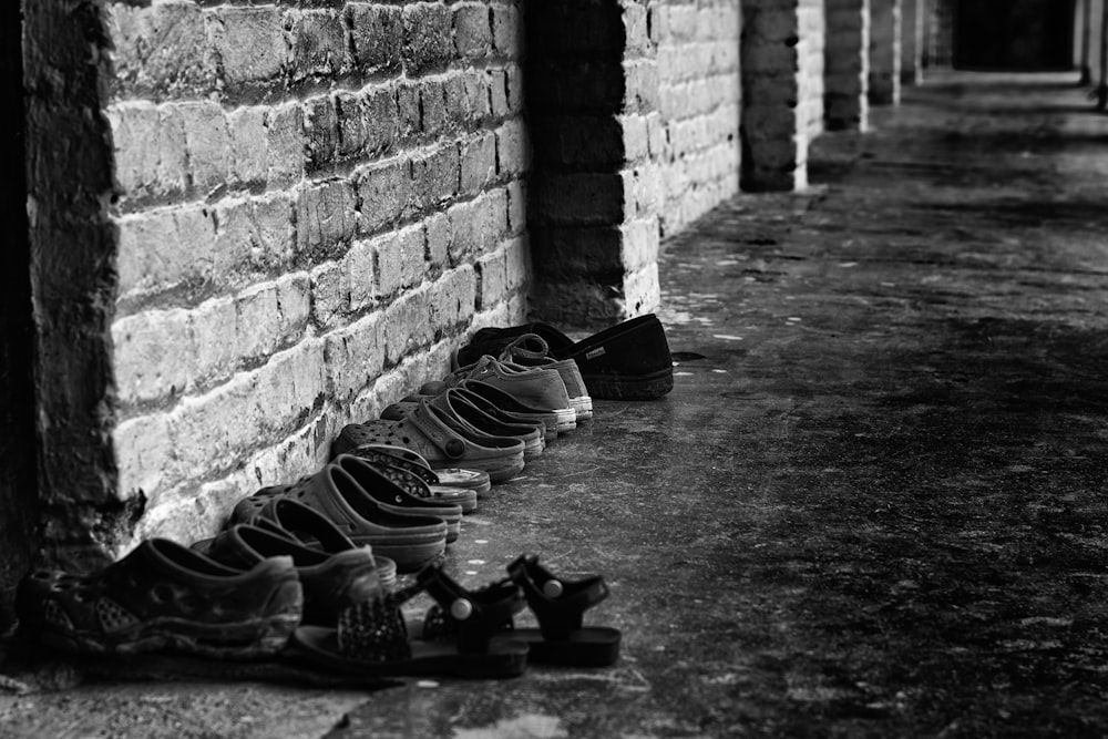 grayscale photo of black and white adidas sneakers