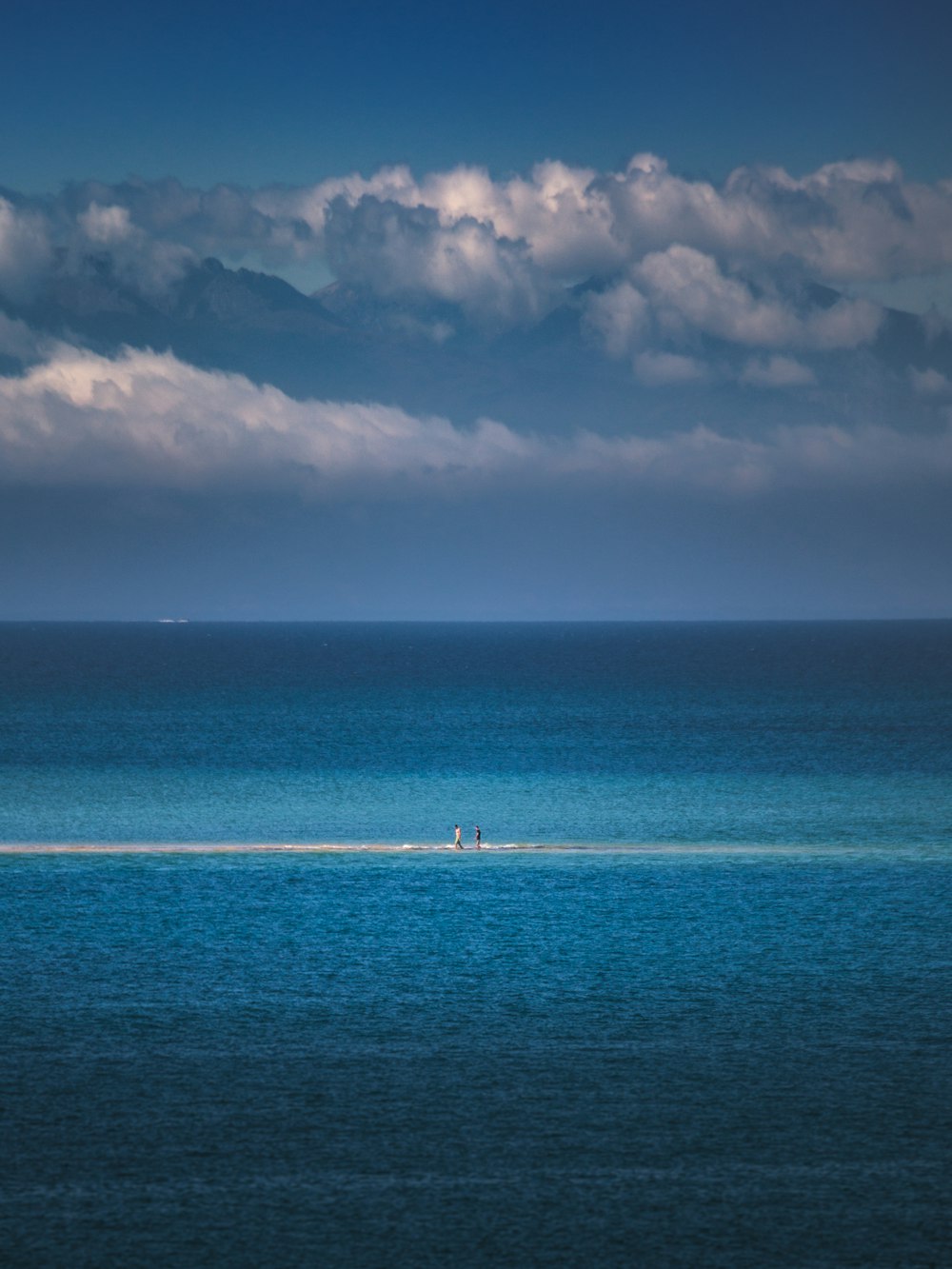 blue sea under white clouds and blue sky during daytime