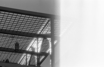 Black and white candid of guests at an event, framed with an experimental grid overlay and electric blue accents.