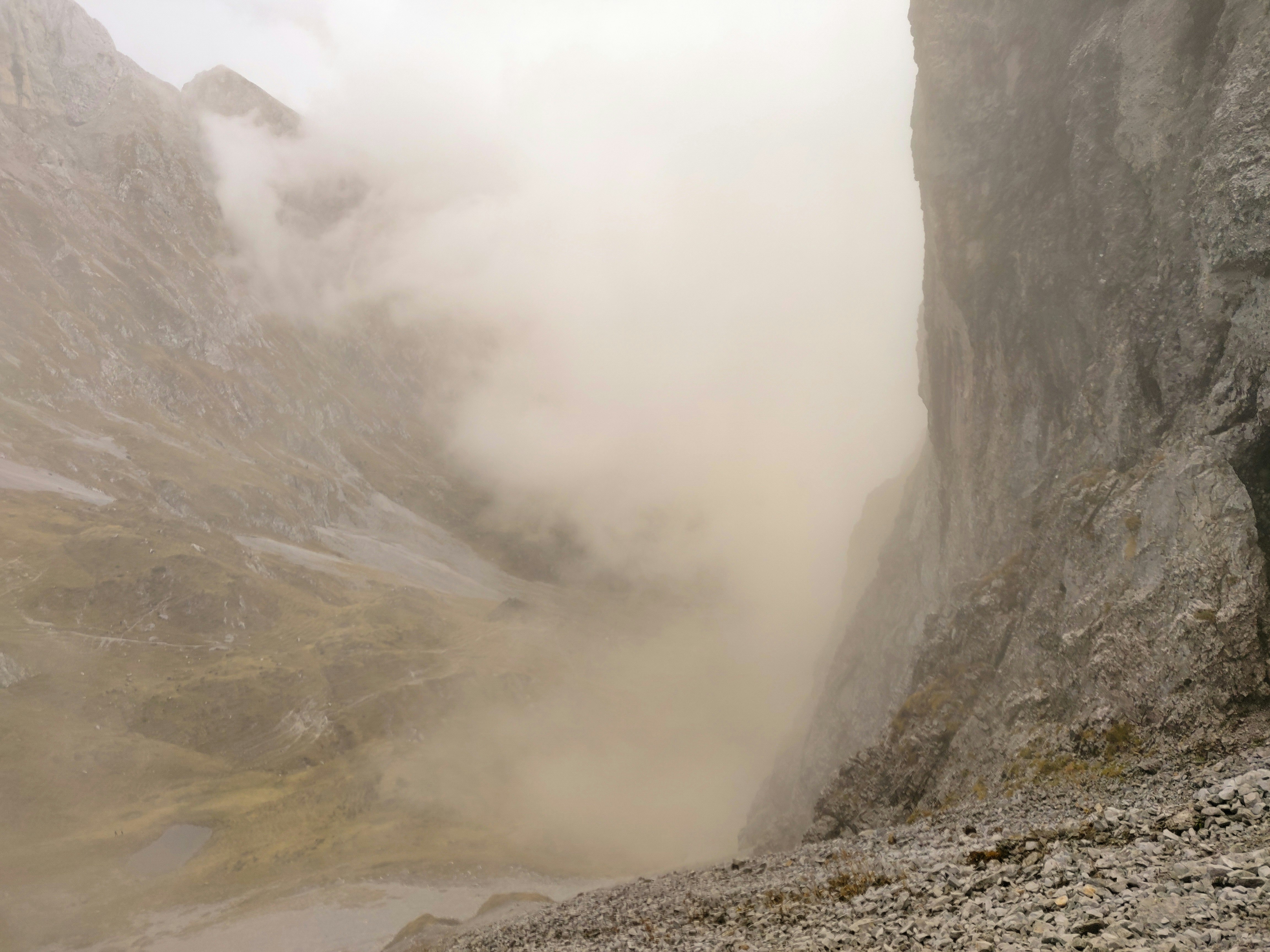 gray rocky mountain with fog