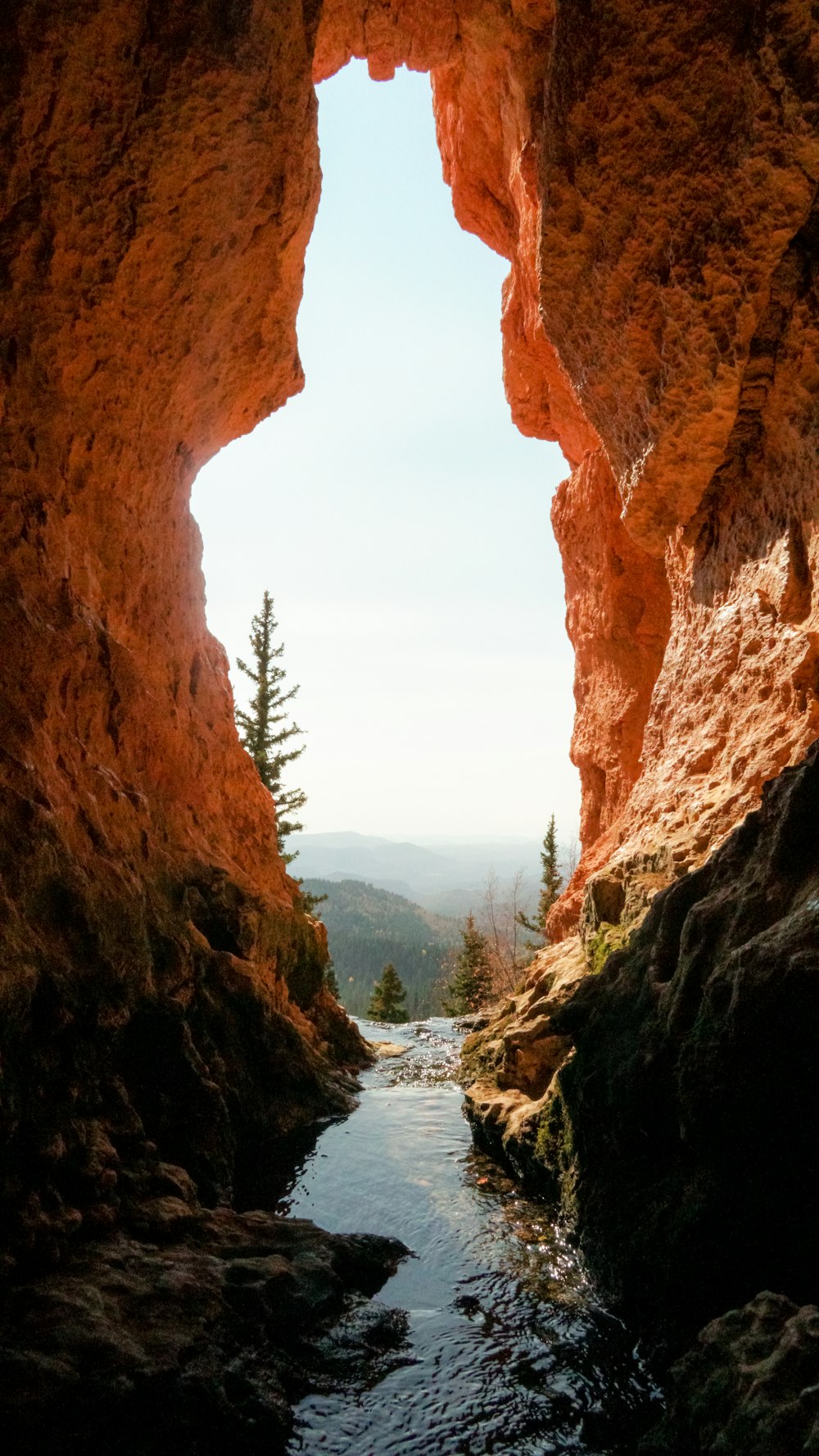 brown rock formation near body of water during daytime