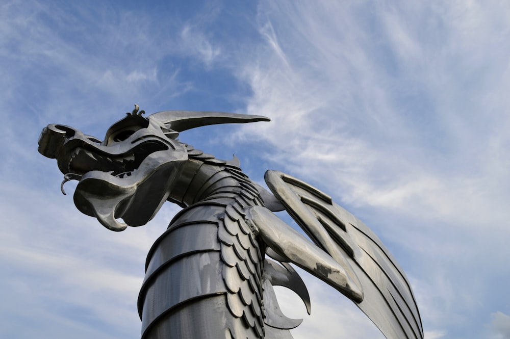 gray dragon statue under blue sky during daytime