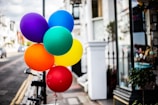 A vibrant storefront banner announcing a weekend sale with colorful balloons.