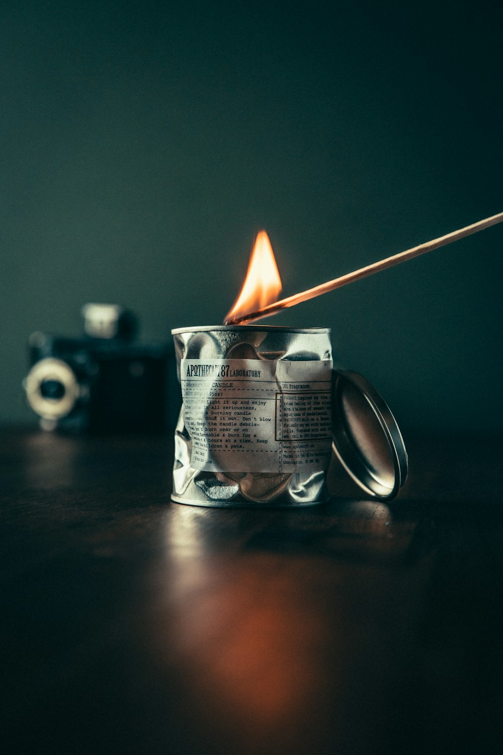 lighted candle on black surface