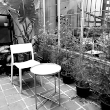 Monochrome image of a refined private villa terrace with subtle lighting and elegant furniture.