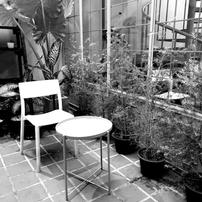 Monochrome image of a refined private villa terrace with subtle lighting and elegant furniture.