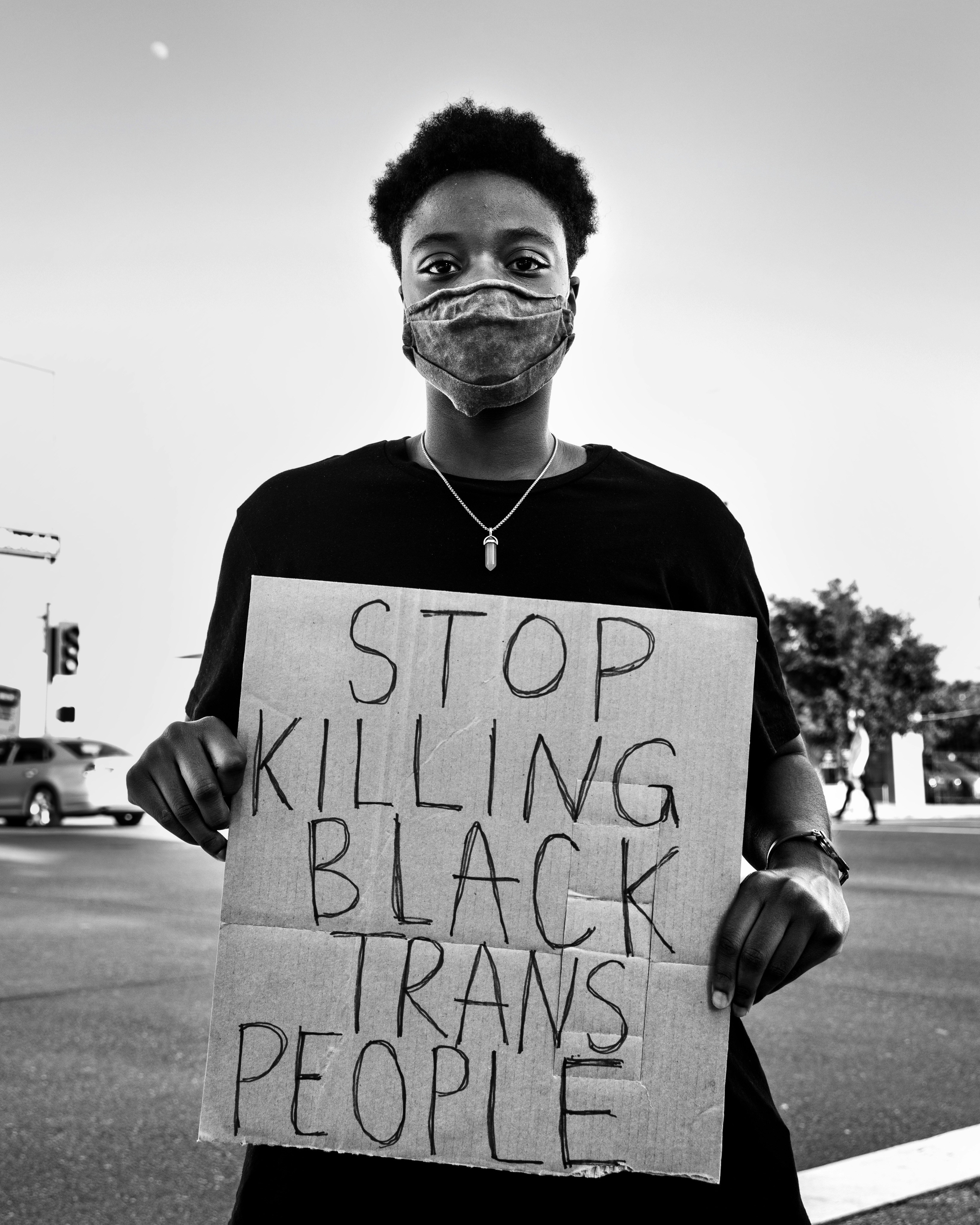 man in black crew neck t-shirt holding white printer paper