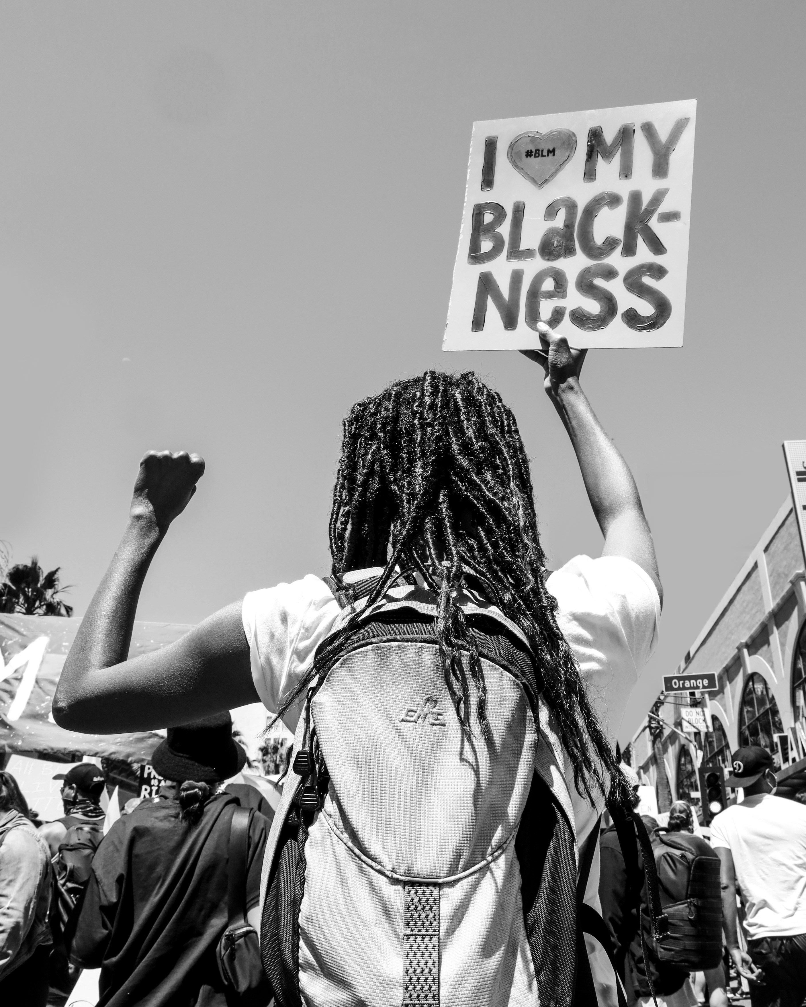 grayscale photo of woman in white t-shirt and backpack