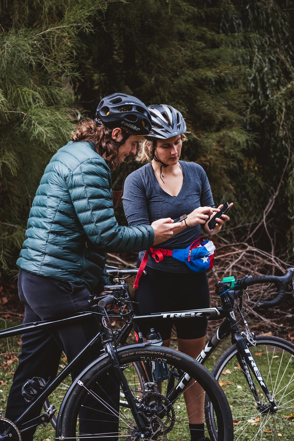 man in black crew neck long sleeve shirt holding blue and black mountain bike