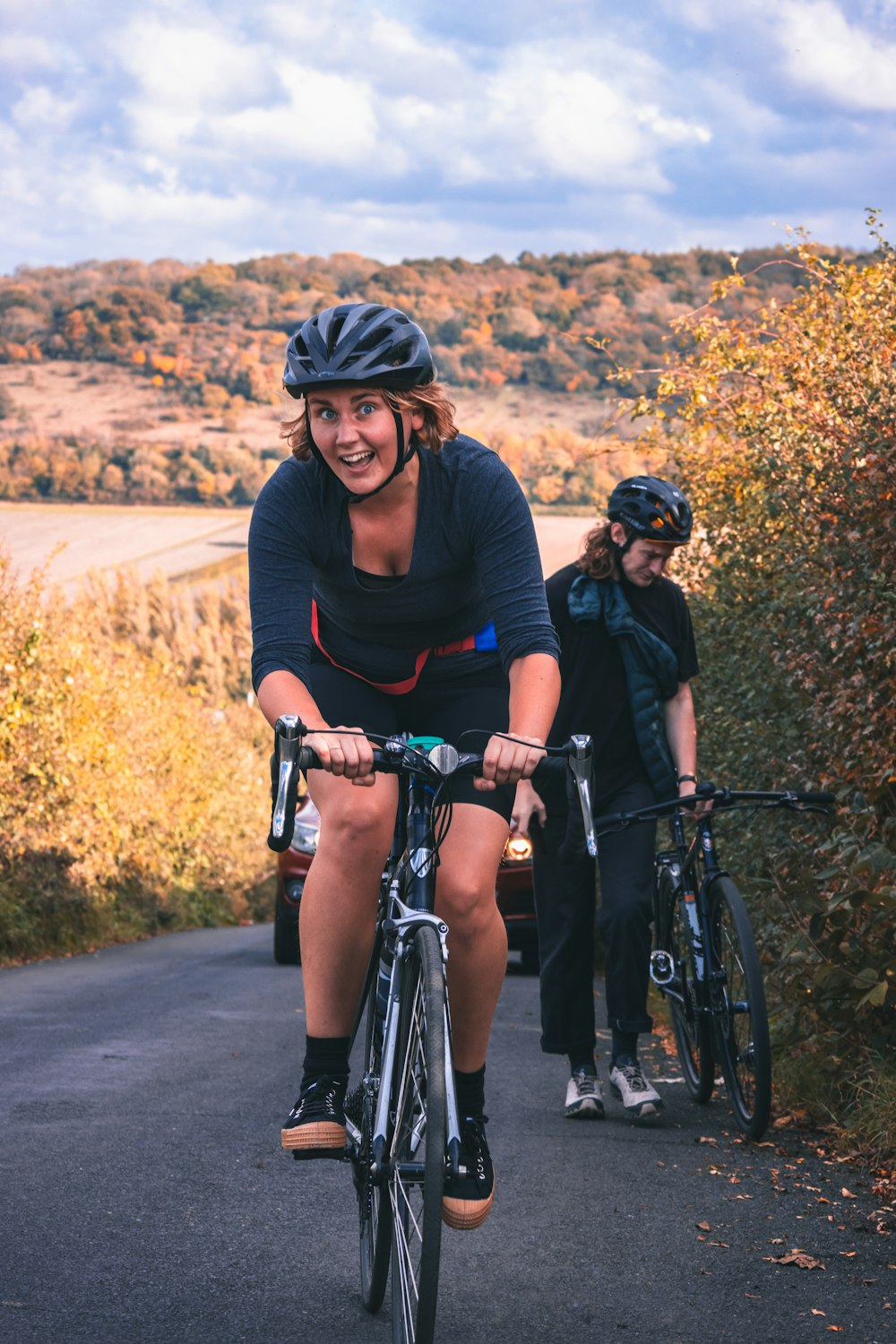 woman in black tank top and black pants riding on bicycle