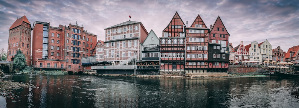 red and white concrete building beside body of water during daytime