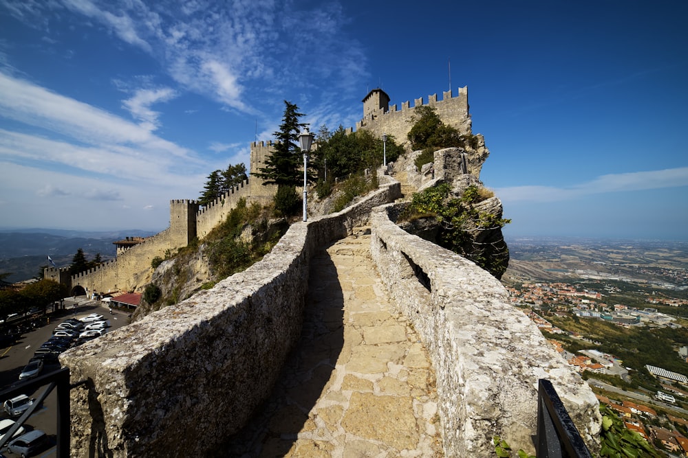 gray concrete castle near body of water during daytime