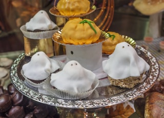 2 white and brown cupcakes on clear glass plate