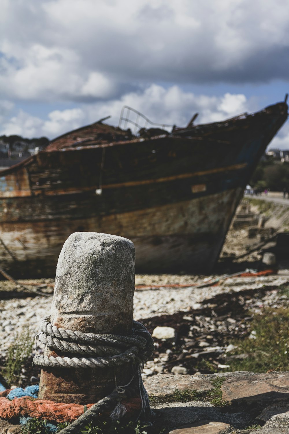 brown and black wooden boat on brown sand during daytime