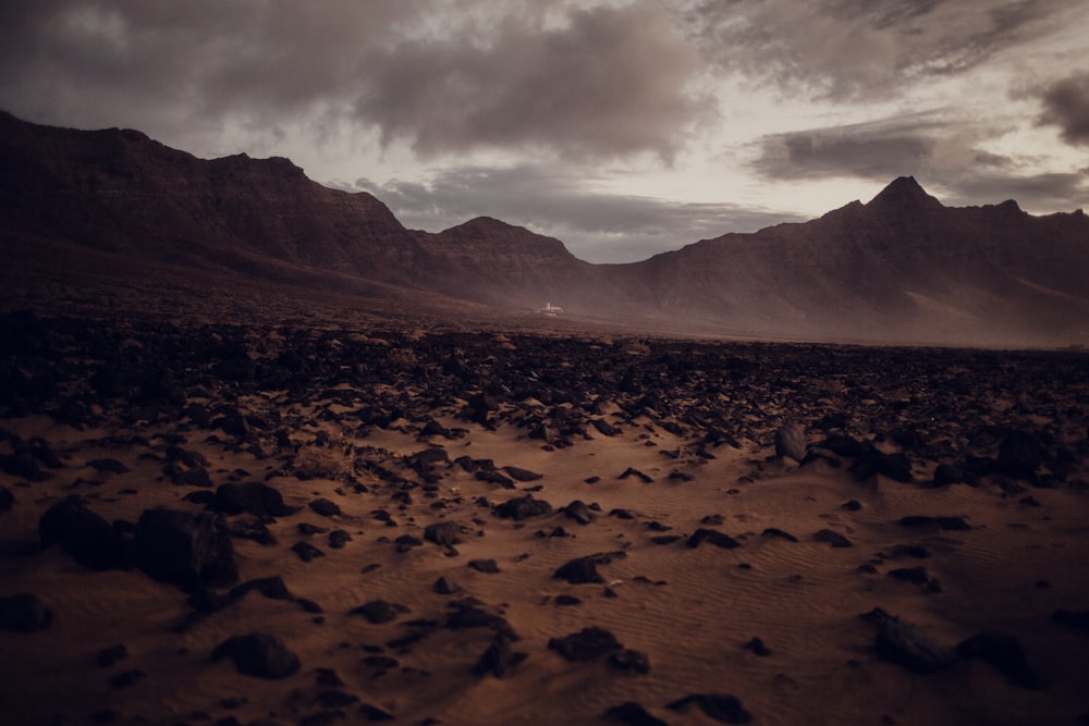 silhouette of mountains under cloudy sky during daytime