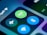 Close-up of a smartphone screen displaying various connectivity icons, including a green Wi-Fi symbol, a blue Bluetooth icon, and an airplane mode icon. The image focuses on the section of the control center, highlighting these options with a blurred background.