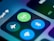 Close-up of a smartphone screen displaying various connectivity icons, including a green Wi-Fi symbol, a blue Bluetooth icon, and an airplane mode icon. The image focuses on the section of the control center, highlighting these options with a blurred background.
