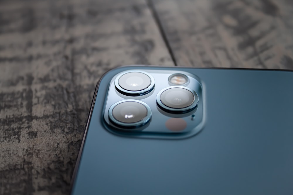 blue and white device on brown marble table