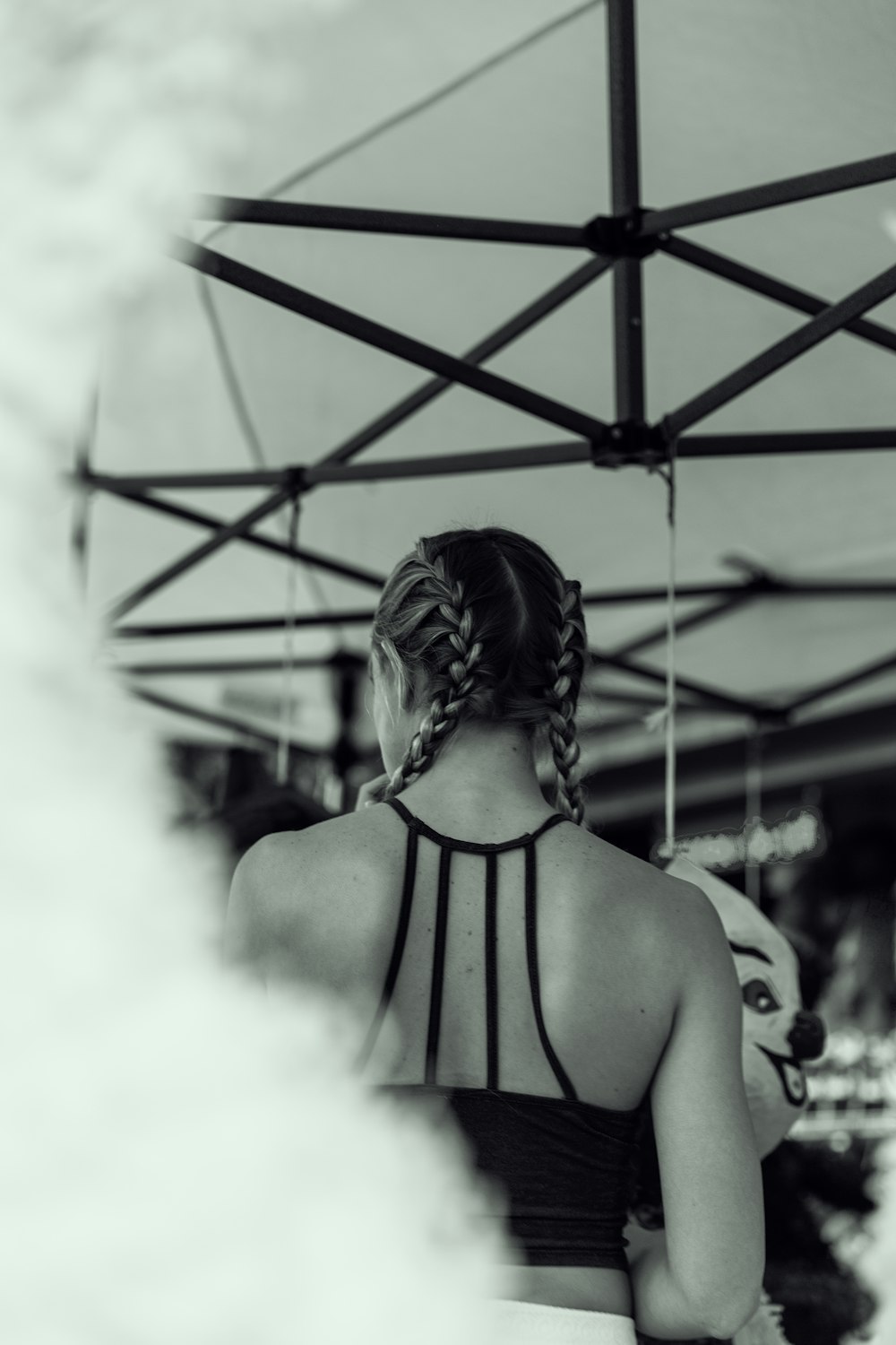 grayscale photo of woman in bikini top smoking