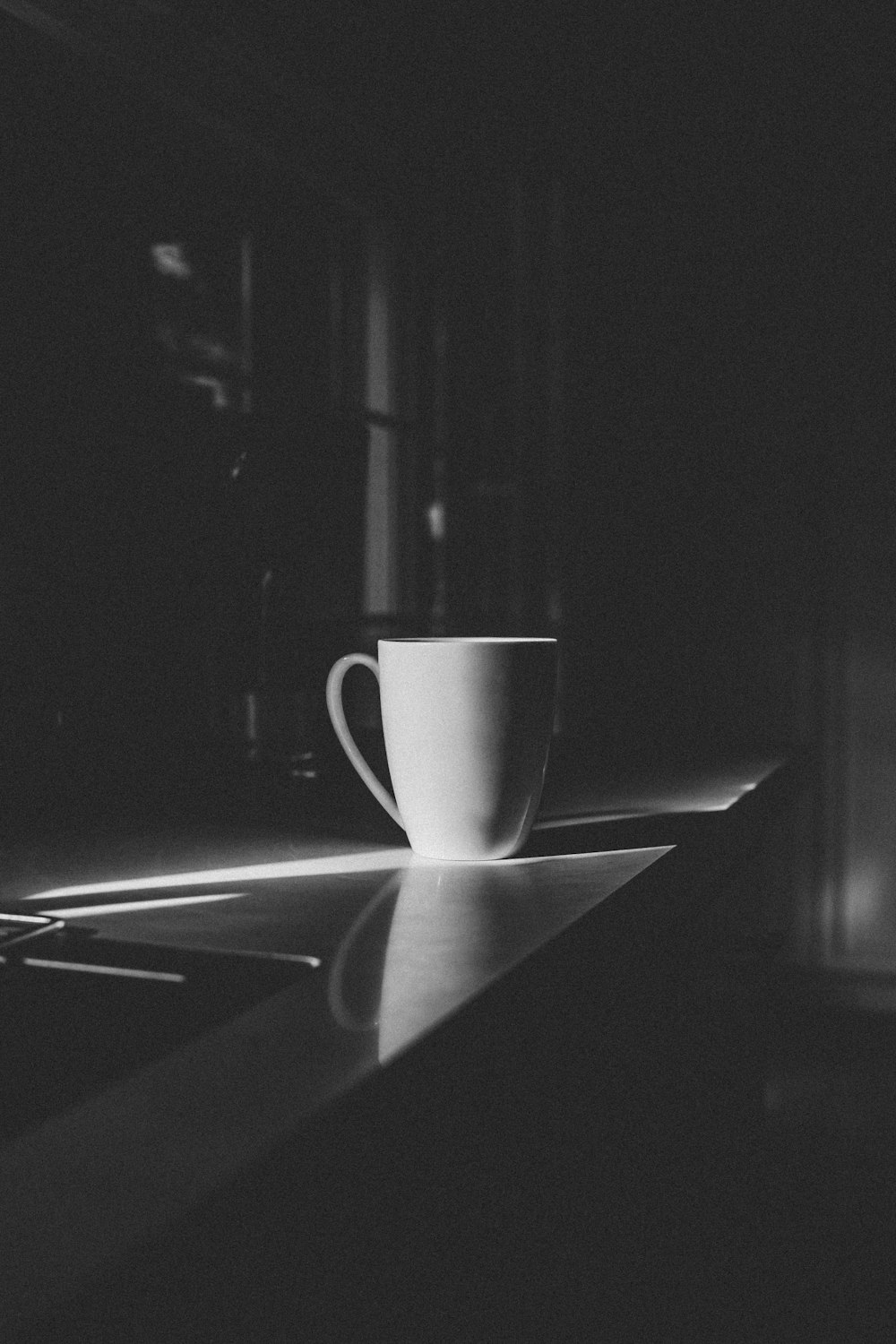 white ceramic mug on white table