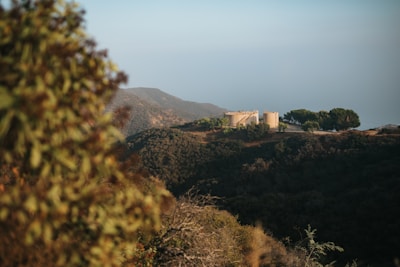 A landscape showing multiple water tanks in a rural setting.