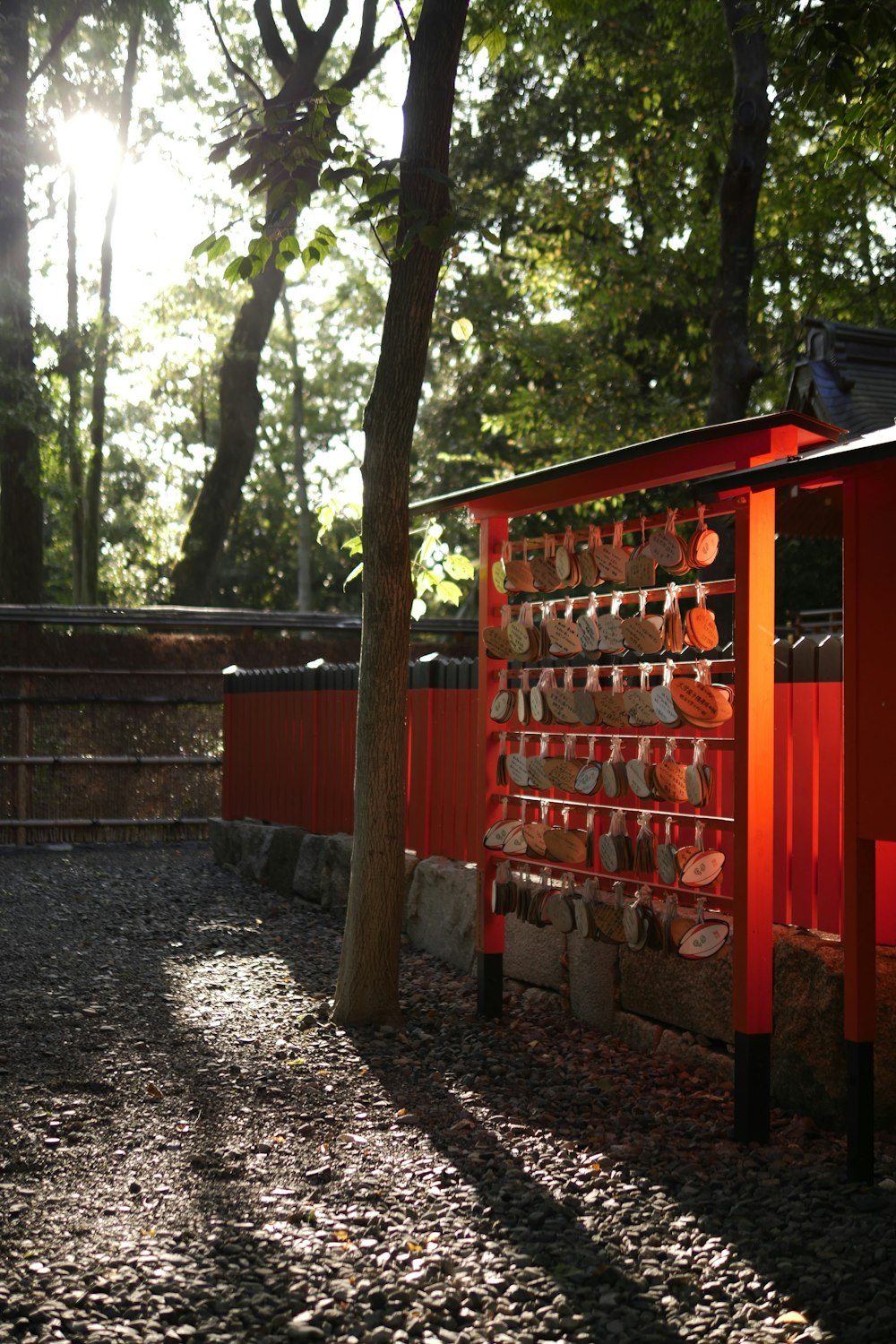 red wooden fence near green trees during daytime