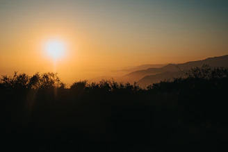 A sunset over a peaceful natural landscape where Sol Naciente ONG has made an impact.