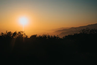A peaceful sunset casting warm light over the scenic rim landscape.