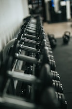 black and silver dumbbells on rack