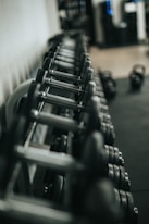 black and silver dumbbells on rack