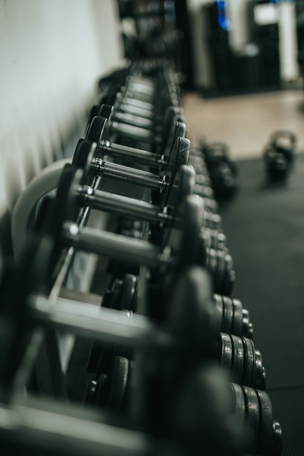 black and silver dumbbells on rack